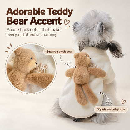 Plush teddy bear accent on the back of a cream dog sweater